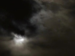 Full moon behind clouds Stock Footage