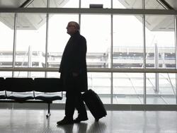 MS Middle aged traveling businessman walking through airport with suitcase / Minneapolis, Minnesota, United States Stock Footage