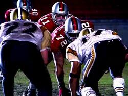 Football player snaps ball into play, quarterback passes ball to runner who is tackled Stock Footage