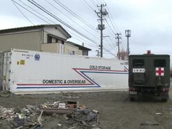 Destruction caused by tsunami after magnitude 9 Tohoku earthquake, north east Japan, March 2011. Shipping container lies in front of house Stock Footage