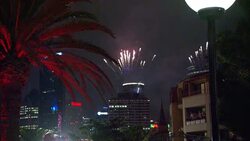 Silver and red fireworks explode over Sydney, Australia during a New Year's celebration. Stock Footage