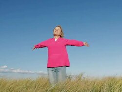 MS Mature woman with outstretched arm in beach grass / Sea Bright, New Jersey, USA Stock Footage