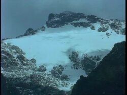MS snow covered Rwenzori Mountain, clouds moving overhead, Uganda, Africa Stock Footage