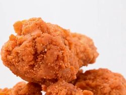 Close up of rotating spicy fried chicken Stock Footage