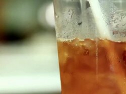 Pouring water in ice coffee Stock Footage