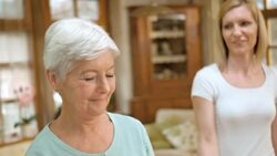 SLO MO Senior woman exercises with nurse supervising her Stock Footage