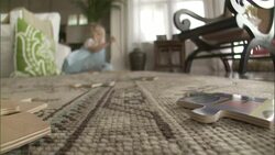 A spider sits on a puzzle piece near a little girl who plays on the floor. Stock Footage