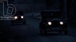Car driving through town at night, 1930s - reenactment, clip 2 Stock Footage