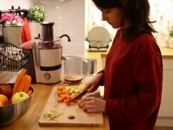 Housewife making a juice at home Stock Footage