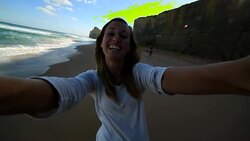 Young woman takes a selfie portrait on Gibsons steps beach Stock Footage