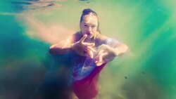 Caucasian woman in dress swimming under water Stock Footage