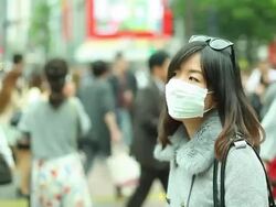 HD:Asian woman wearing a mask standing in a big city. Stock Footage