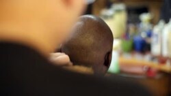 Barber shaves and brushes hair off man's head in New York City barbershop Stock Footage
