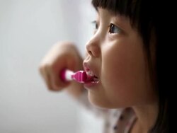 Asian female child enjoying her tooth brushing routine Stock Footage