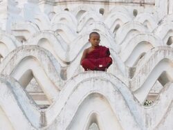 WS View of young monk praying, sitting on huge white temple steps  / Mandalay, Mandalay Division, Myanmar Stock Footage