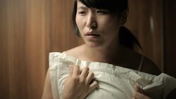 Sad teenage Asian girl crying with tears holding pillow. Stock Footage