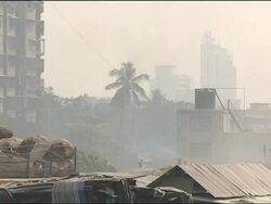 Smog hangs over piles of rubbish and the skyline of Mumbai Stock Footage