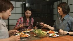 Three young women preparing food in the kitchen Stock Footage