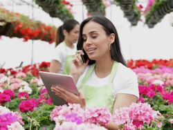 MS PAN Woman talking on cell phone in floral business / Richmond, Virginia,United States Stock Footage