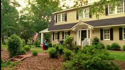 A family arrives at their suburban home with luggage. Stock Footage
