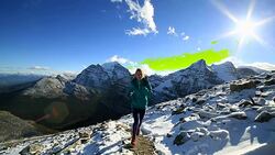 Woman running cross-country, spectacular mountains scenery Stock Footage