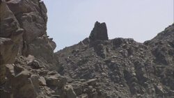 An overcast sky outlines a rock formation in the ancient city of Sikait, Egypt. Stock Footage