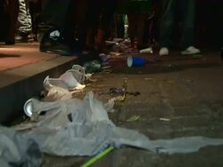 Medium Close Up POV - Trash lining sidewalk on Bourbon Street  / New Orleans Louisiana Stock Footage