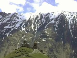 WS T/L Shot of gergeti trinity church and caucasus mountainsat background / Stepantsminda, Kazbegi, Georgia  Stock Footage