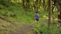 Ultra marathon runner running outdoors in the woods Stock Footage