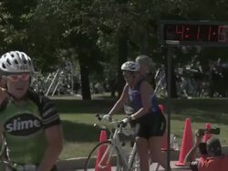 MS triathletes running by timer with bicycles / Chicago, Illinois, USA Stock Footage