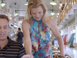 MS middle aged man sipping on a date shake in deli section of health food store as his wife joins him at the table carrying a sandwich with potato chips in basket tray and sitting down to drink date shake / Cabazon, California, USA Stock Footage