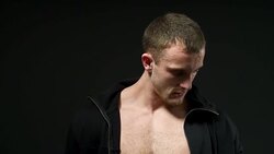 handsome young man with good muscles in a cape over a black background Stock Footage