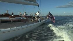 Passengers relax on the deck of the large sloop Heroina as they sail off Newport, Rhode Island. Stock Footage