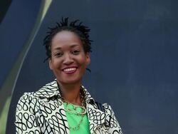 MS TD TU Portrait of smiling businesswoman in front of office building sculpture / Richmond, Virginia, United States Stock Footage