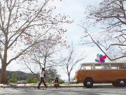 WS Skater passing through in front of two women sitting near to car  / Los Angeles, California, United States  Stock Footage
