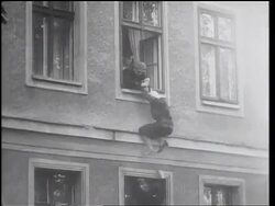 B/W 1961 East Berlin guards try to pull woman into window as West Berliners pull her to ground Stock Footage