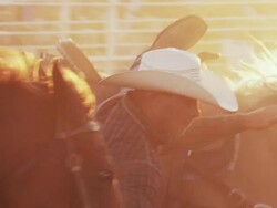 Cowboy races out the gate and brings down a steer by the horns at a rodeo - shot in slow motion. Stock Footage