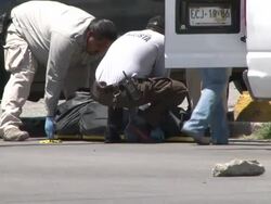 MS PAN View of Dead gun shot victim on the streets AUDIO / Ciudad Juarez, Juarez, Mexico Stock Footage