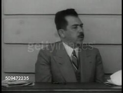 1939: MEXICO PRESIDENT CARDENAS: EXT MS President Lazaro Cardenas sitting at table w/ male assistants. MS Cardenas talking (no SOT). CU Border post 'Republica Mexicana.' WS Mexican landscape, mountains BG, cactuses FG. Instructional Video