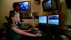 MS Producer advising editor working at computer in studio/ New York, New York Stock Footage