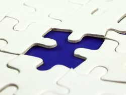 Hand places piece into puzzle Stock Footage