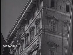 1940: VATICAN CITY MAINTENANCE: Workers, laborers eating lunch outside near building rubble & wood pile. Scaffold ropes outside building, men pulling ropes attached to scaffolding platform, TU LS men working on roof. Instructional Video