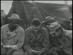 1944: BATTLE OF AITAPE: VS U.S. Navy transport ships at sea, U.S. 163rd Infantry Regiment soldiers on deck cleaning rifles, eating, writing letter, talking. NIGHT: VS Soldiers on watch on deck, manning anti-aircraft guns. WWII, Pacific Front Instructional Video