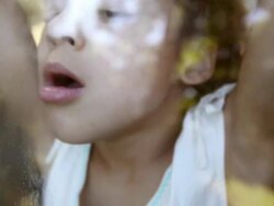 Girl breathing on car window and drawing in condensation Stock Footage