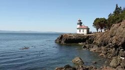 The lighthouse at Lime Kiln State Park on San Juan Island on a sunny day. Stock Footage
