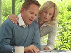 Medium shot of male and female at dinning table looking at personal finance Stock Footage