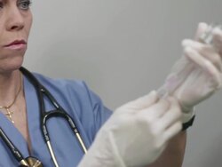 Female nurse applying vaccine to a girl Stock Footage