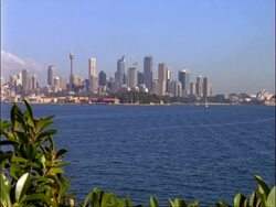 WA Sydney Harbour, pan from high rise skyline to Opera House and Harbour Bridge, Sydney, Australia Stock Footage