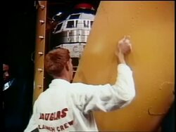 1962 men removing yellow panel to reveal Telstar (first communications satellite) / documentary Stock Footage