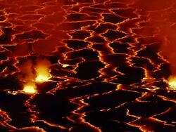 MS Molten rock cooling and forming plates on surface of lava lake / Goma, Virunga National Park, Democratic Republic of the Congo Stock Footage